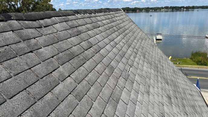 Whitmore Lake shingles on ridge of home's roof before roof replacement