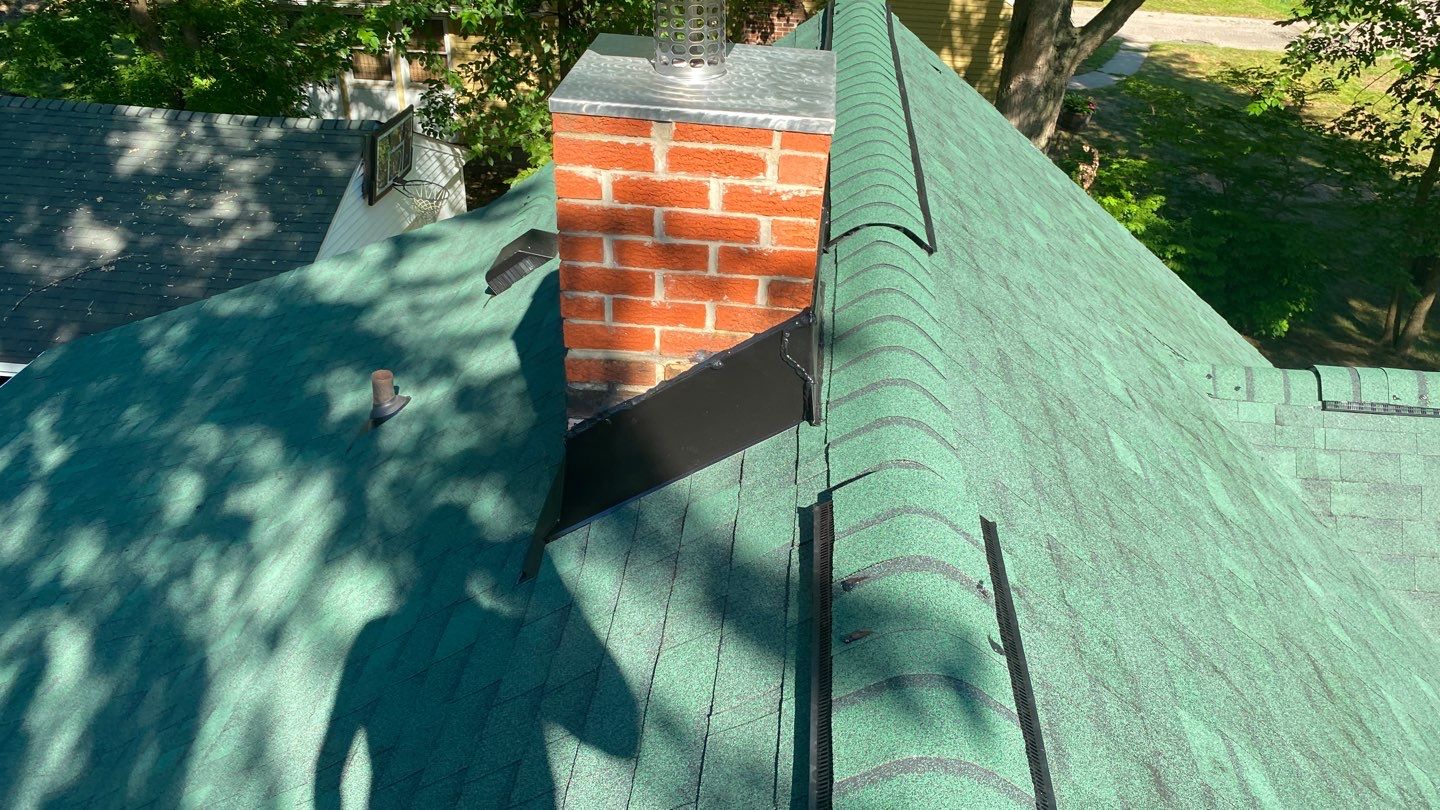The top of Robert's Garden City home and chimney flashing after roof replacement.