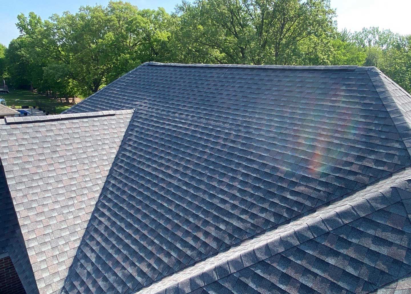 New Baltimore roof replacement project showcasing a completed roof with dark gray asphalt shingles, demonstrating quality and craftsmanship in roofing solutions.