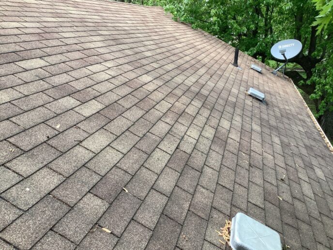 Before image of a worn roof needing replacement in Westland, featuring old shingles, vents, and a satellite dish. Roof-before.jpg showcases the roof's condition.