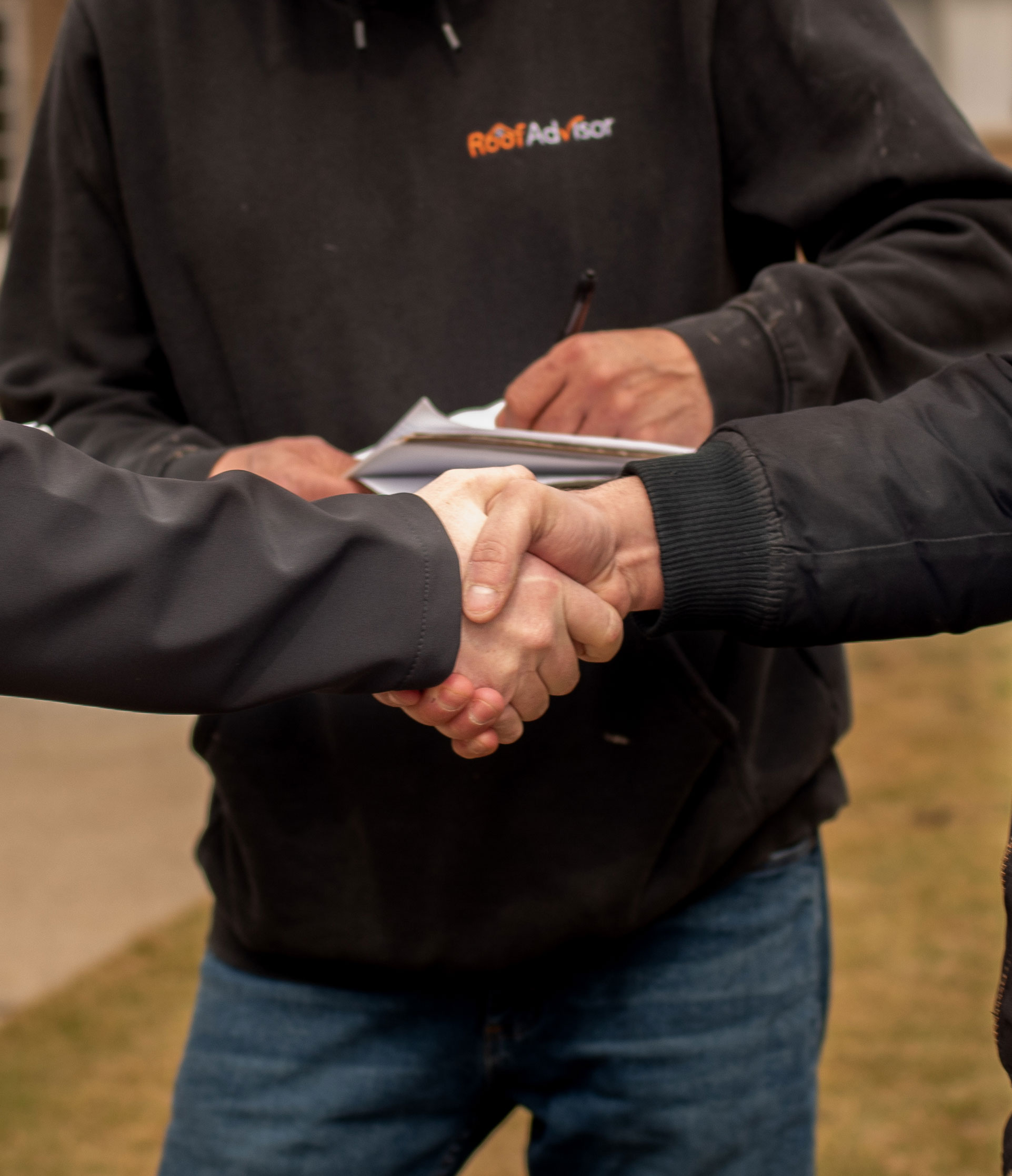 Handshake with RoofAdvisor Preferred Contractor certified installer. Securing trust and quality for your roofing project.