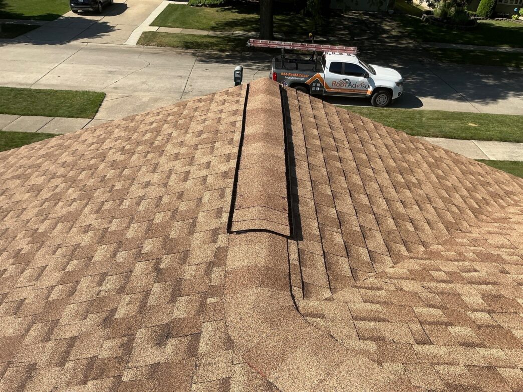 Newly installed roof with RoofAdvisor work truck in the background.