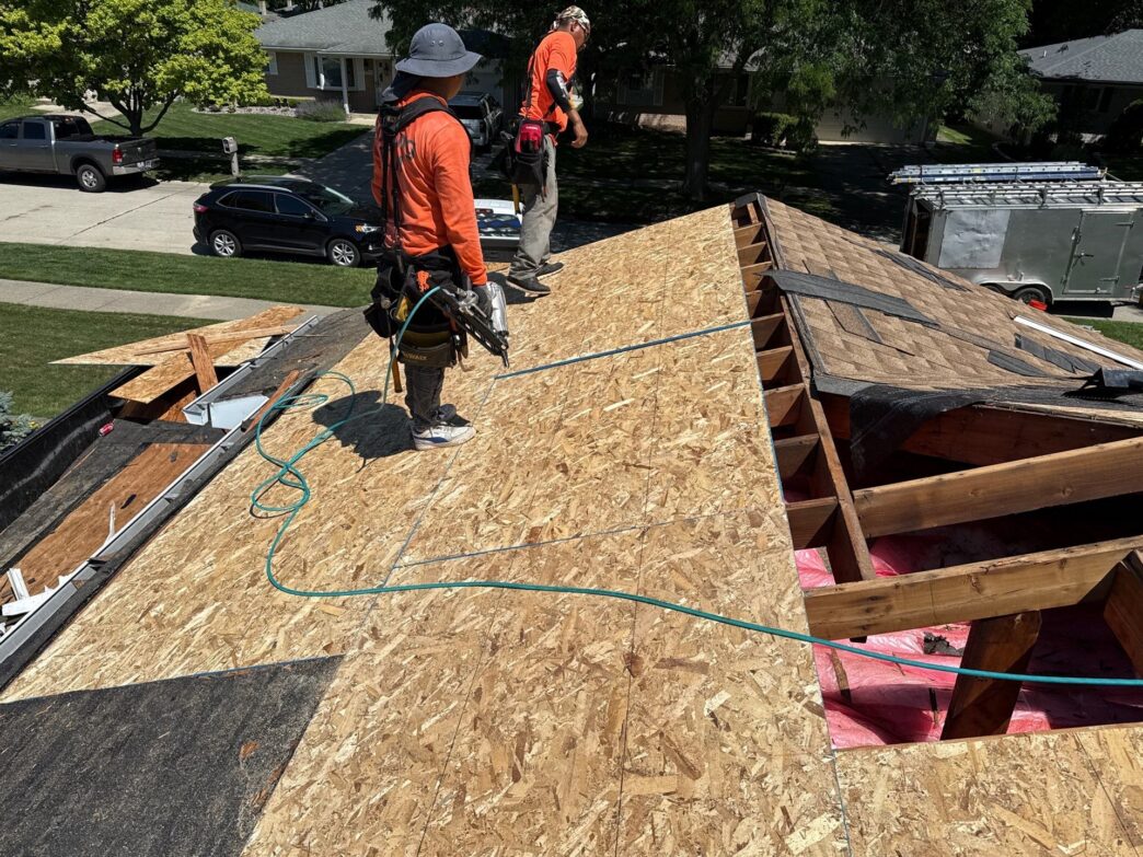 Workers rebuilding the roof decking