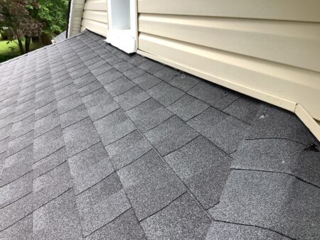 Westland roof replacement: Close-up of a wall-intersection after the new roof installation, showcasing the precise shingle alignment and flashing details.